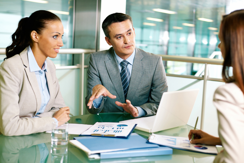 Serious Businessman Talking Giving Presentation On Flipchart